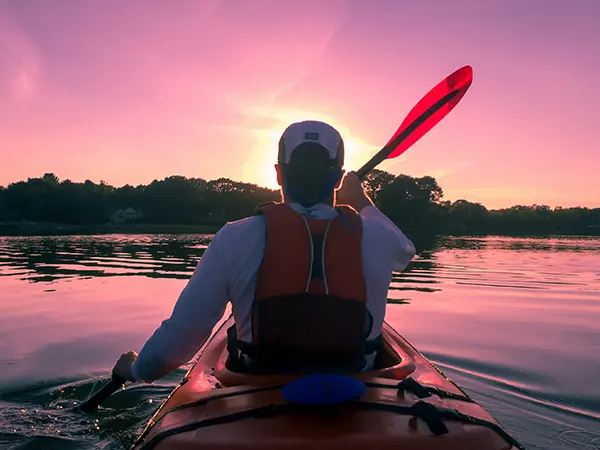 Person kayaking on the calm waters of the Groot Brak River