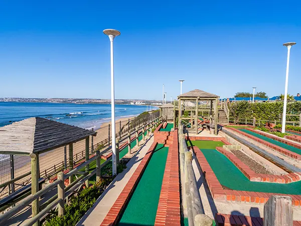 Family playing mini golf at a Hartenbos family attraction