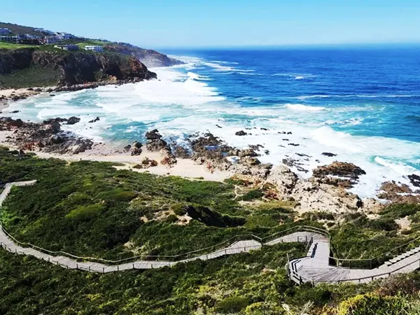 Wooden boardwalk trail along the cliffs at Pinnacle Point